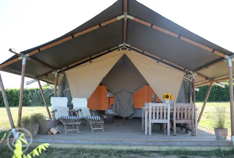 Safari tent exterior with outdoor seating
