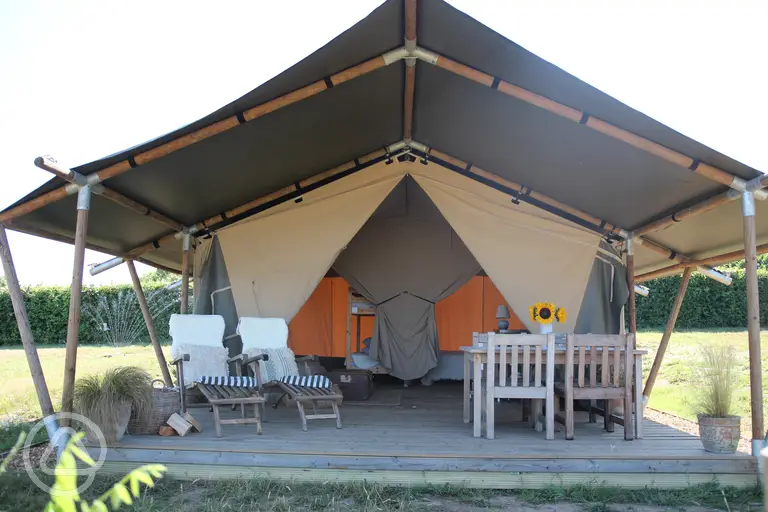 Safari tent exterior with outdoor seating