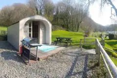 Camping pods (dog friendly) exterior with outdoor picnic benches and BBQs