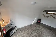 Camping pods interior with a kettle and a fridge