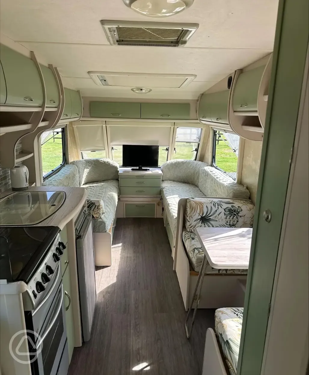 Caravan interior with kitchen, seating and lounge area