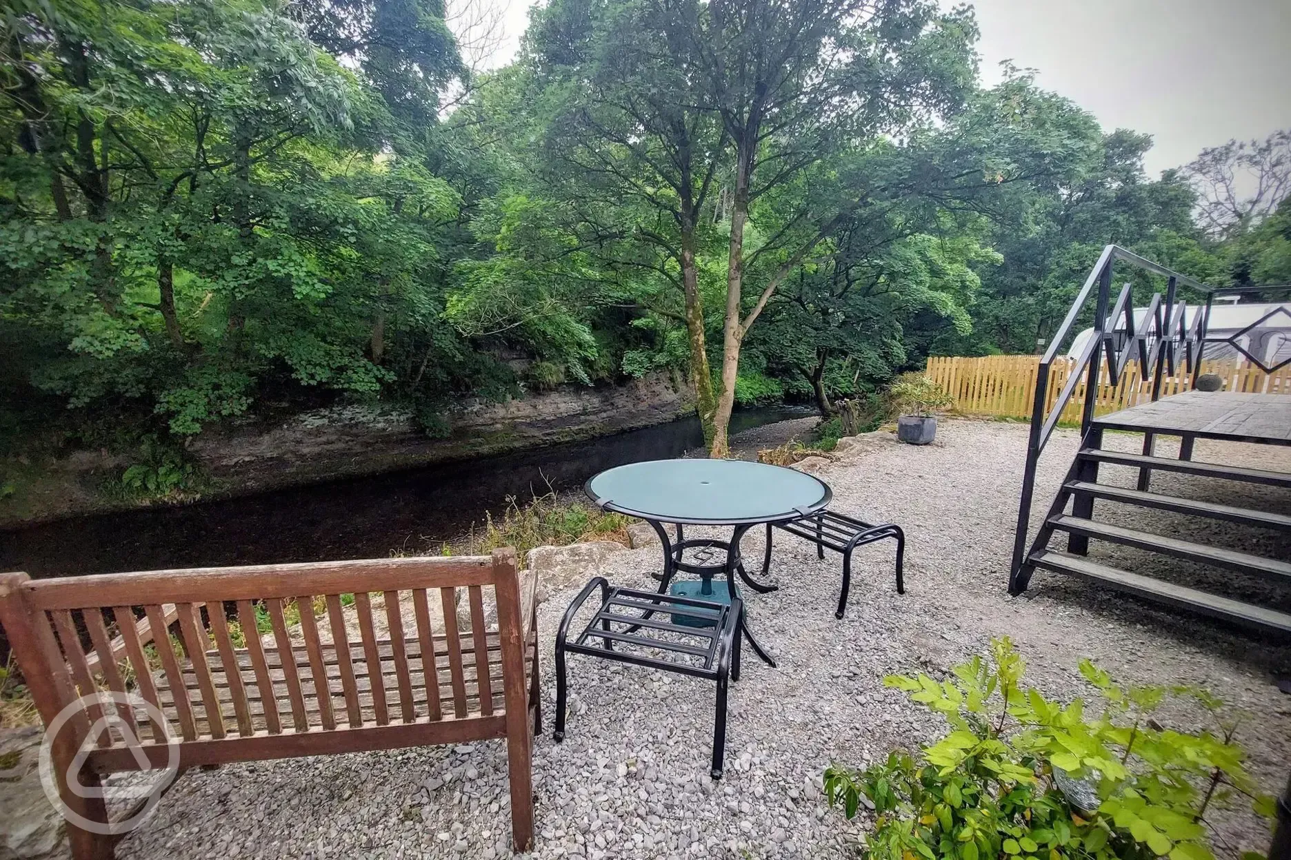 Jack's shepherd's hut outdoor seating by the river