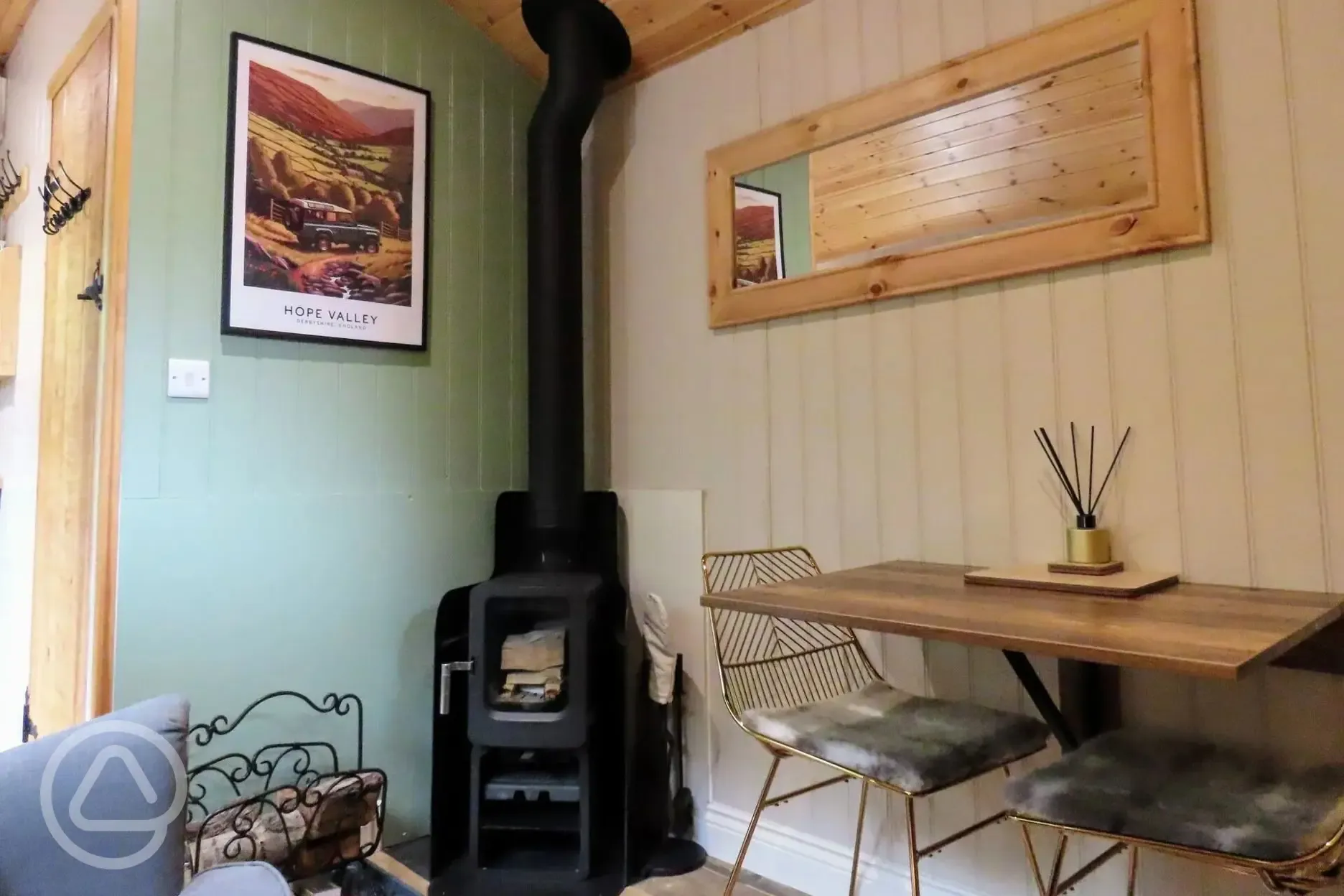 Jack's shepherd's hut interior with log burner and seating