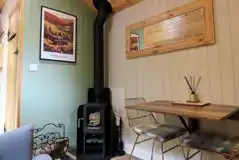 Jack's shepherd's hut interior with log burner and seating Jack's shepherd's hut interior with log burner and seating
