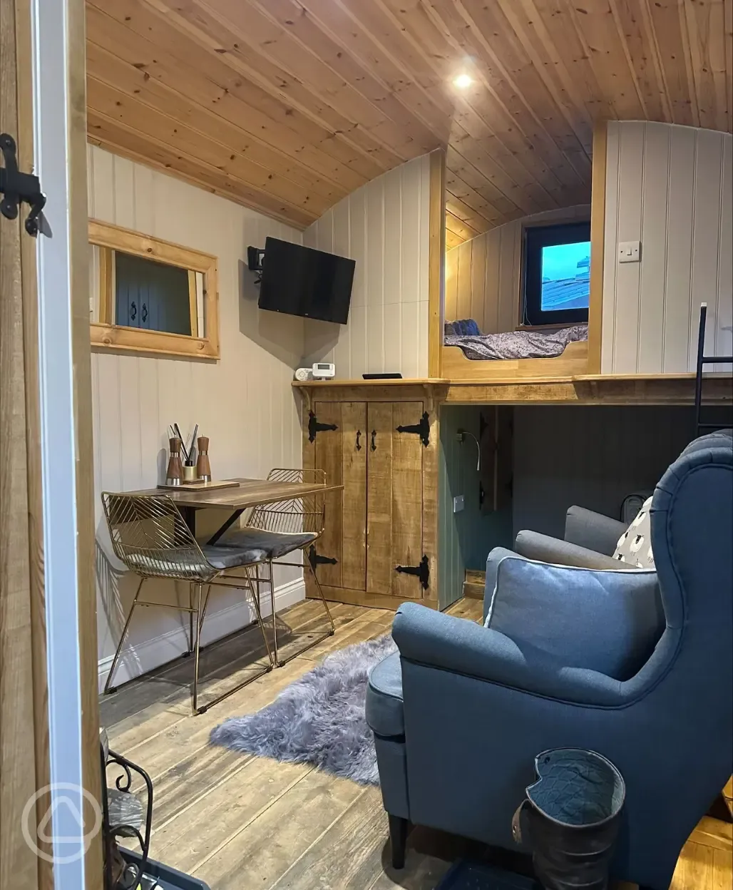 Jack's shepherd's hut interior with double bed and day bed