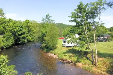 Grass pitches with views of the River Irt