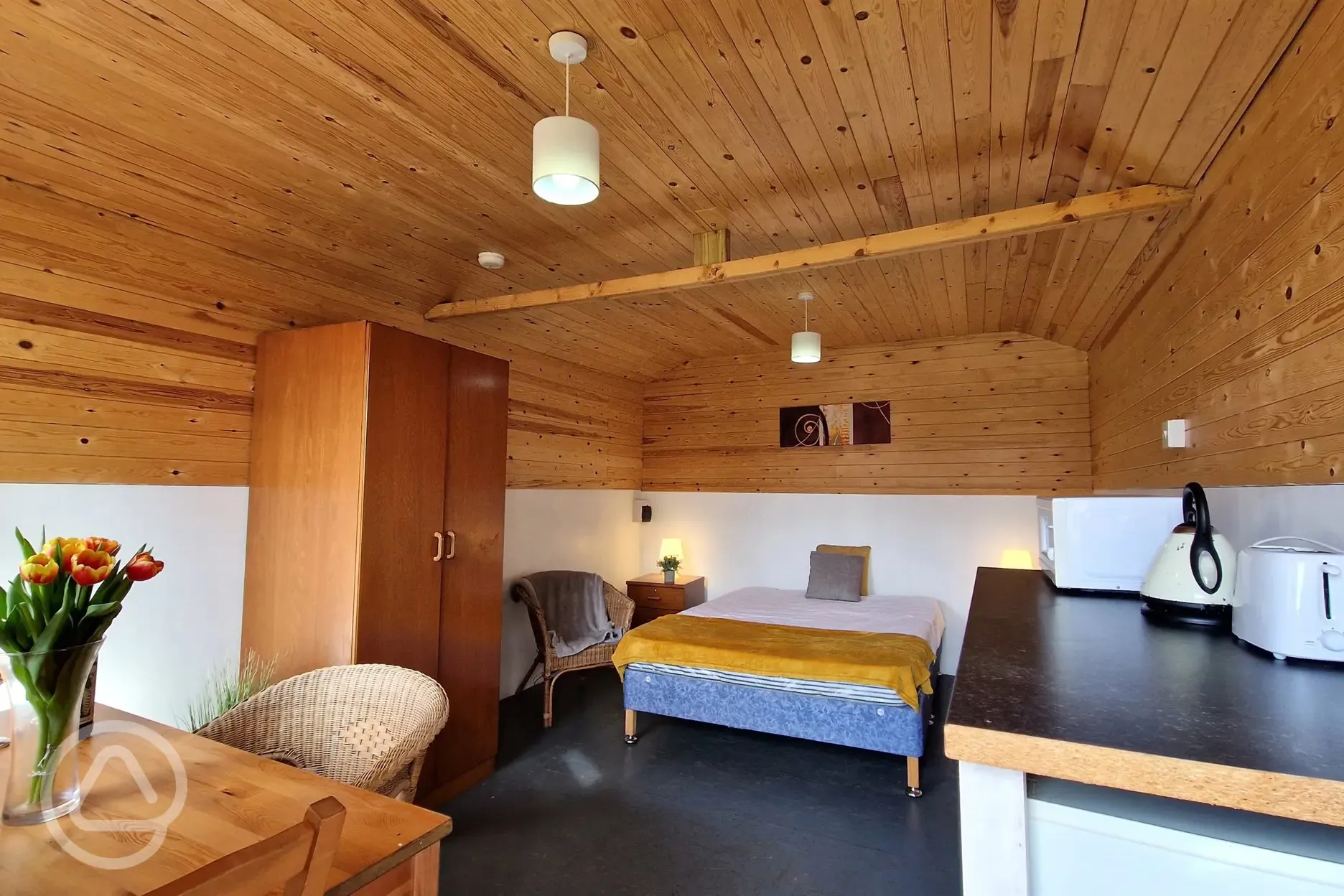 Two person Hill View huts at Budle Bay with a double bed and kitchenette