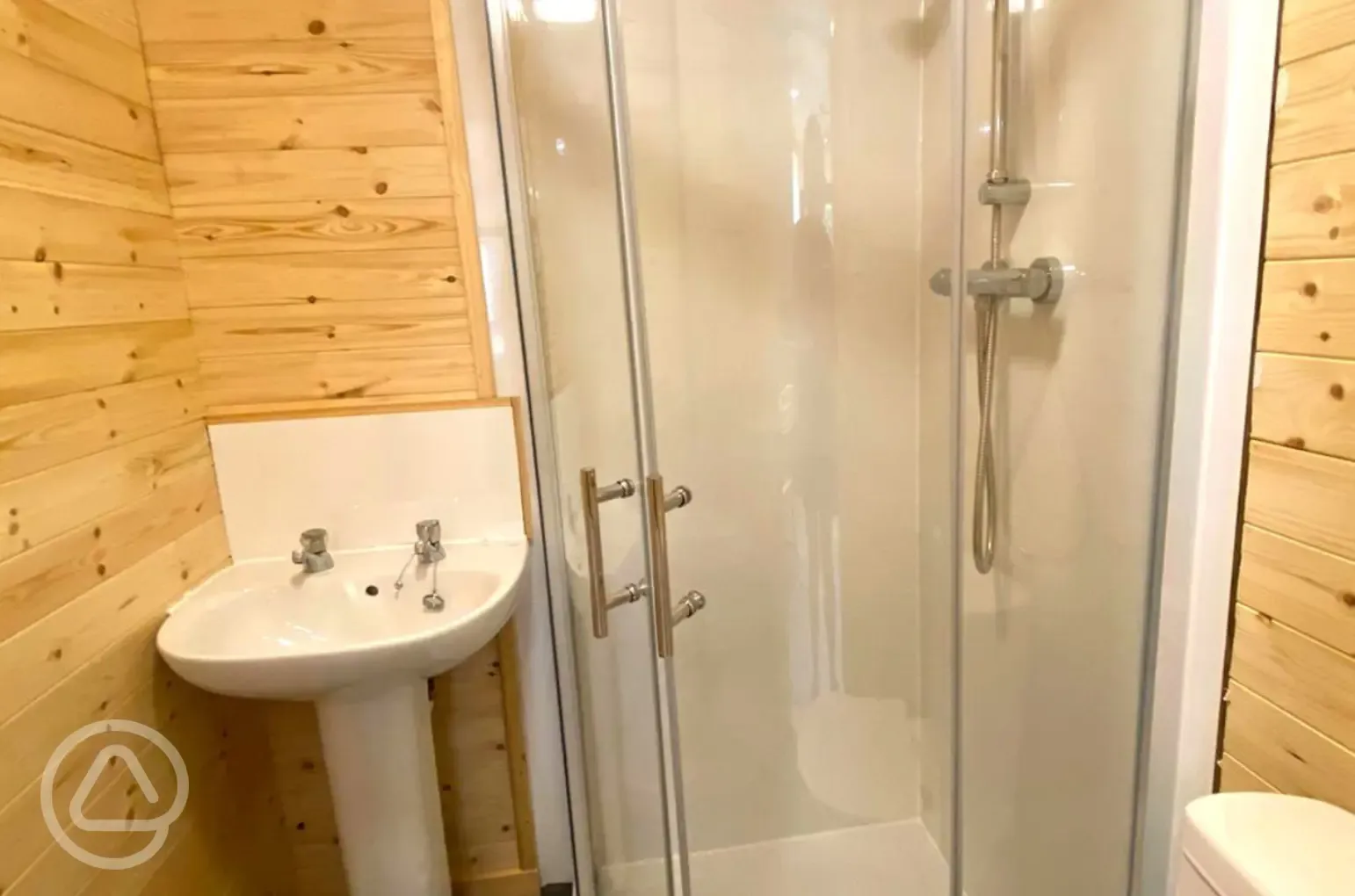 Pine/Ash lodge ensuite bathroom with a shower, toilet, and sink