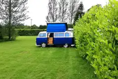 VW campervan on an electric grass pitches