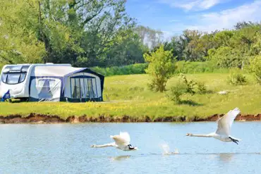 Caravan on optional electric grass pitches with awning space by the fishing lake