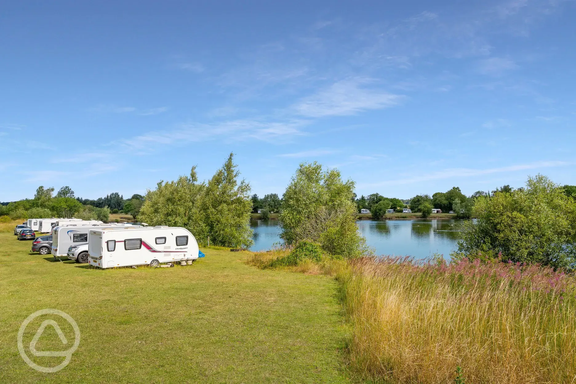 Optional electric grass pitches beside the fishing lake  Optional electric grass pitches beside the fishing lake
