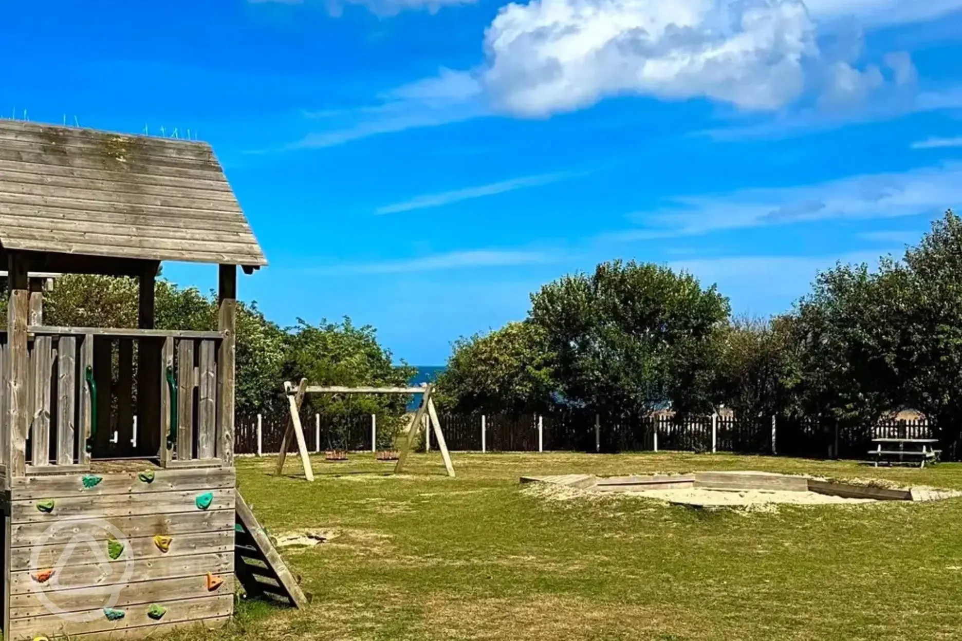 Children's play area with climbing frame and sandpit