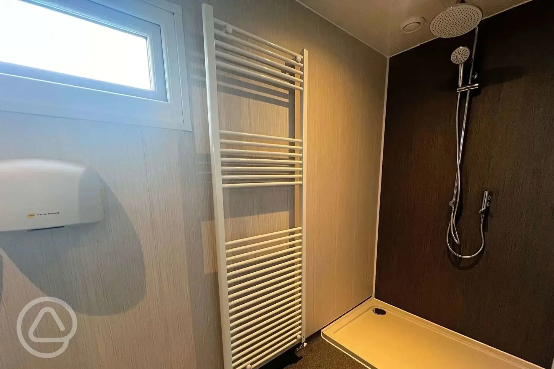 Shower with hand dryer and heated towel rail
