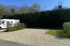 Electric hardstanding pitches surrounded by hedges