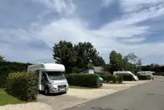 Electric hardstanding pitches with hedges for privacy