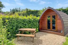 Camping pod exterior with private outdoor dining area