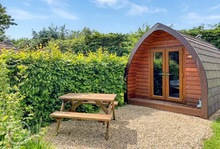 Camping pod exterior with private outdoor dining area