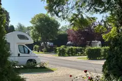 Electric hardstanding pitch with gravel and grass area with space for an awning