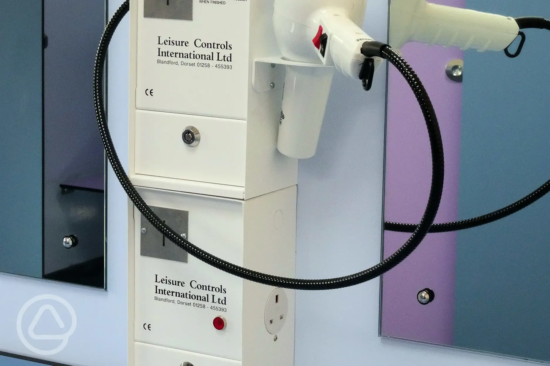 Hairdryers with plug sockets in the shower block at Stubcroft Farm Campsite