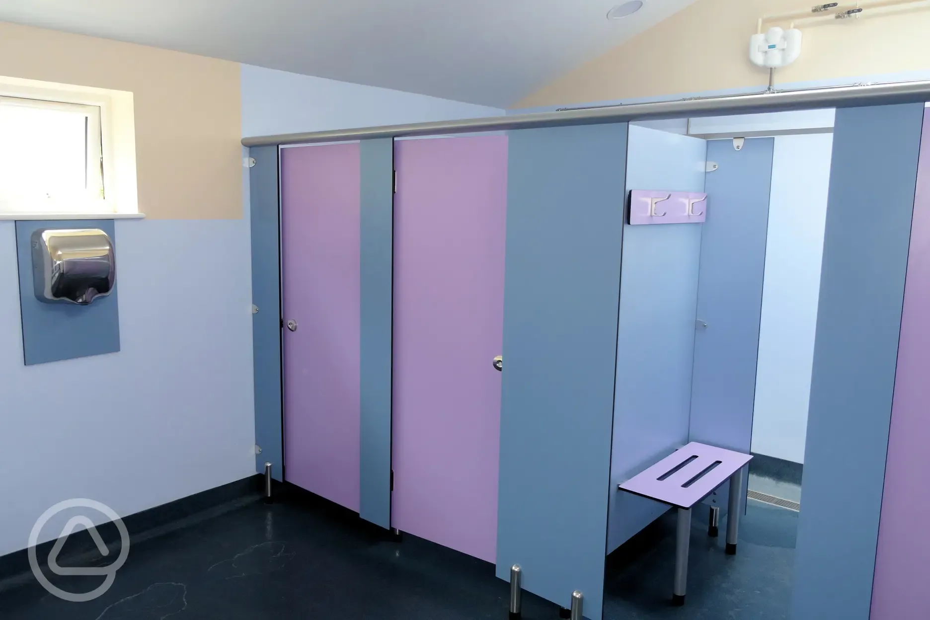 Heated shower block with hooks and benches at Stubcroft Farm Campsite