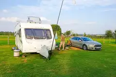 Electric grass caravan pitch with space for a parked car