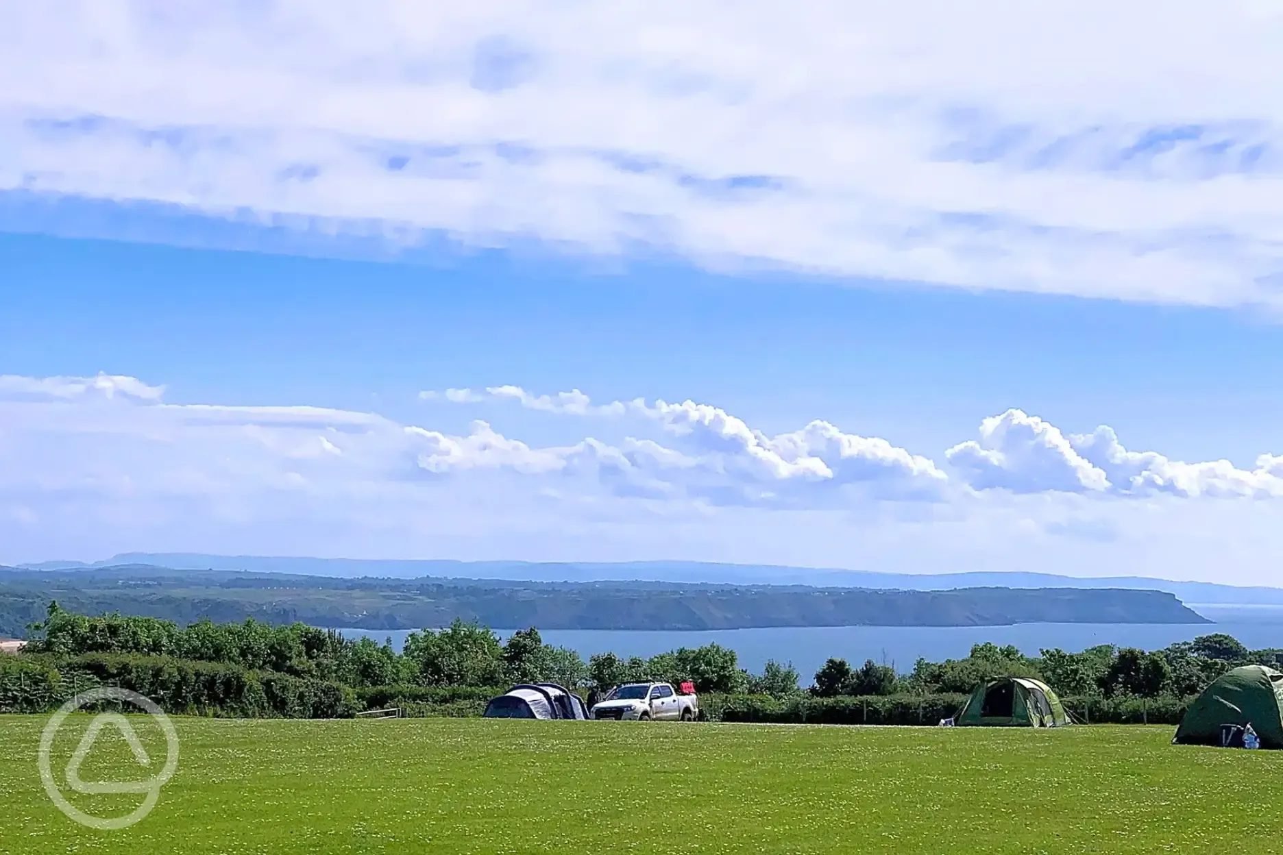 Non electric grass pitches with views of Oxwich Bay