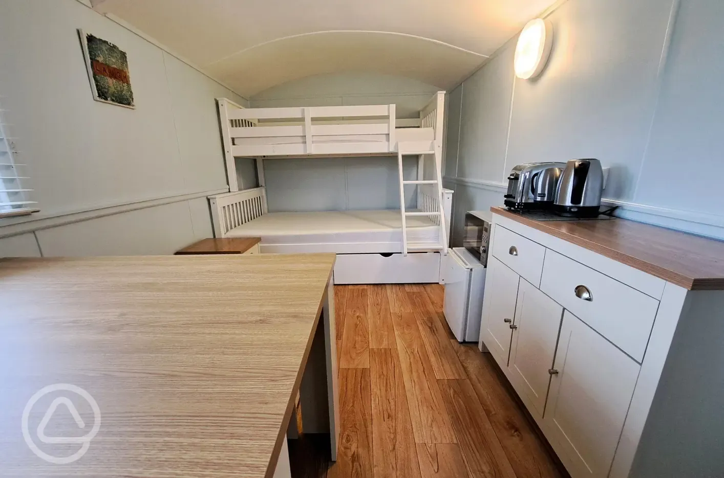 Shepherd's hut interior with a double bed and bunk bed (bring bedding)