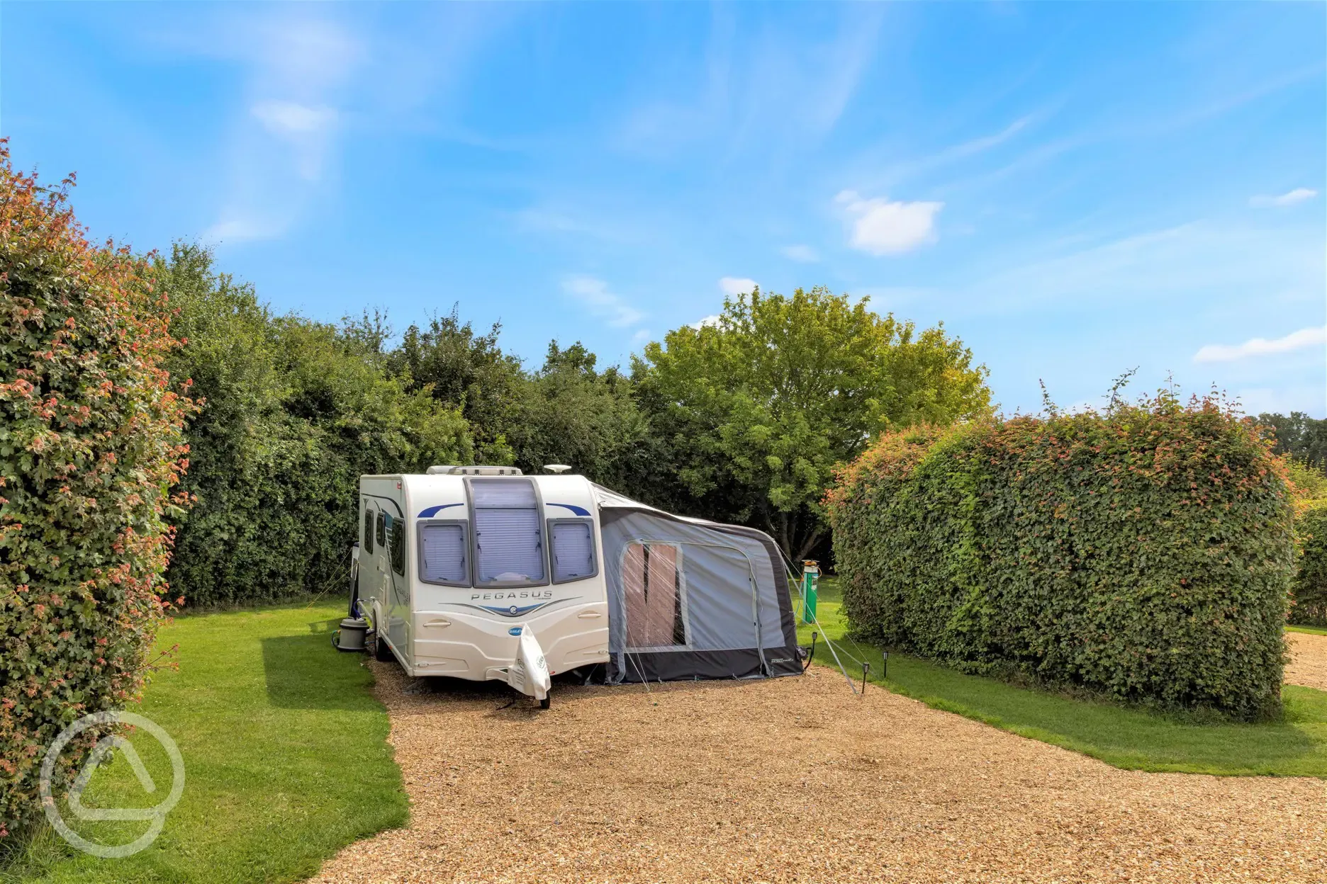 Serviced hardstanding pitches with privacy hedging between each pitch