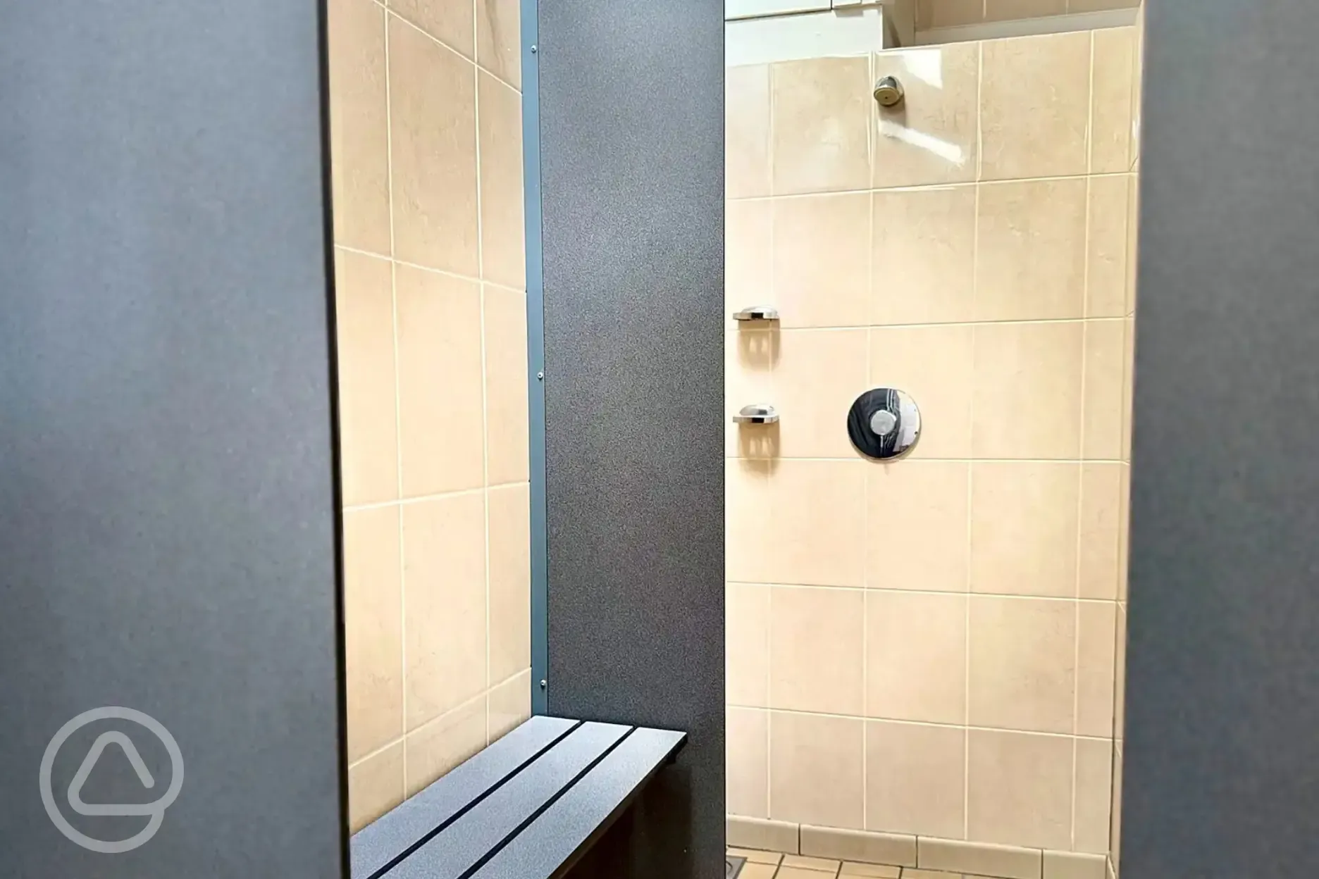 Shower cubicles with a bench and room for getting changed