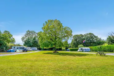 Camping field at Browns Farm with picnic benches
