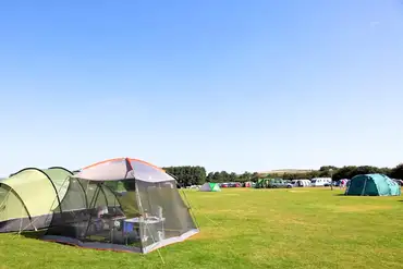 Grass pitches with space for a parked car at Moorland View Park