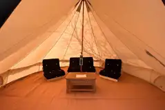 Bell tent interior with a double futon and two single futons