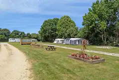 Electric grass pitches with planters and picnic benches