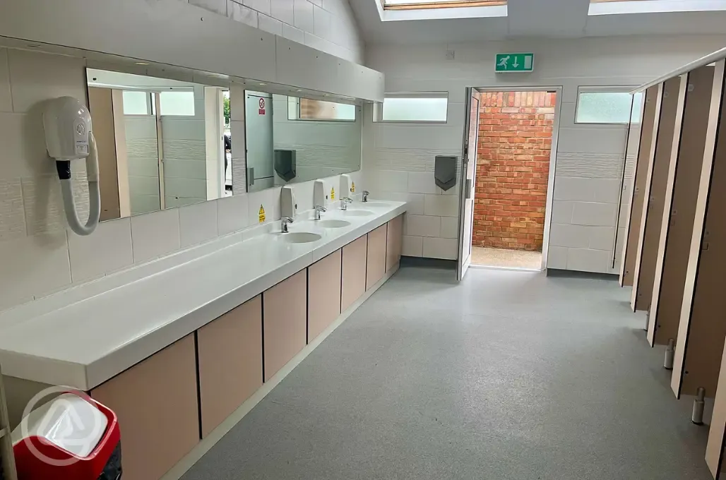 Female toilets with a communal hair dryer