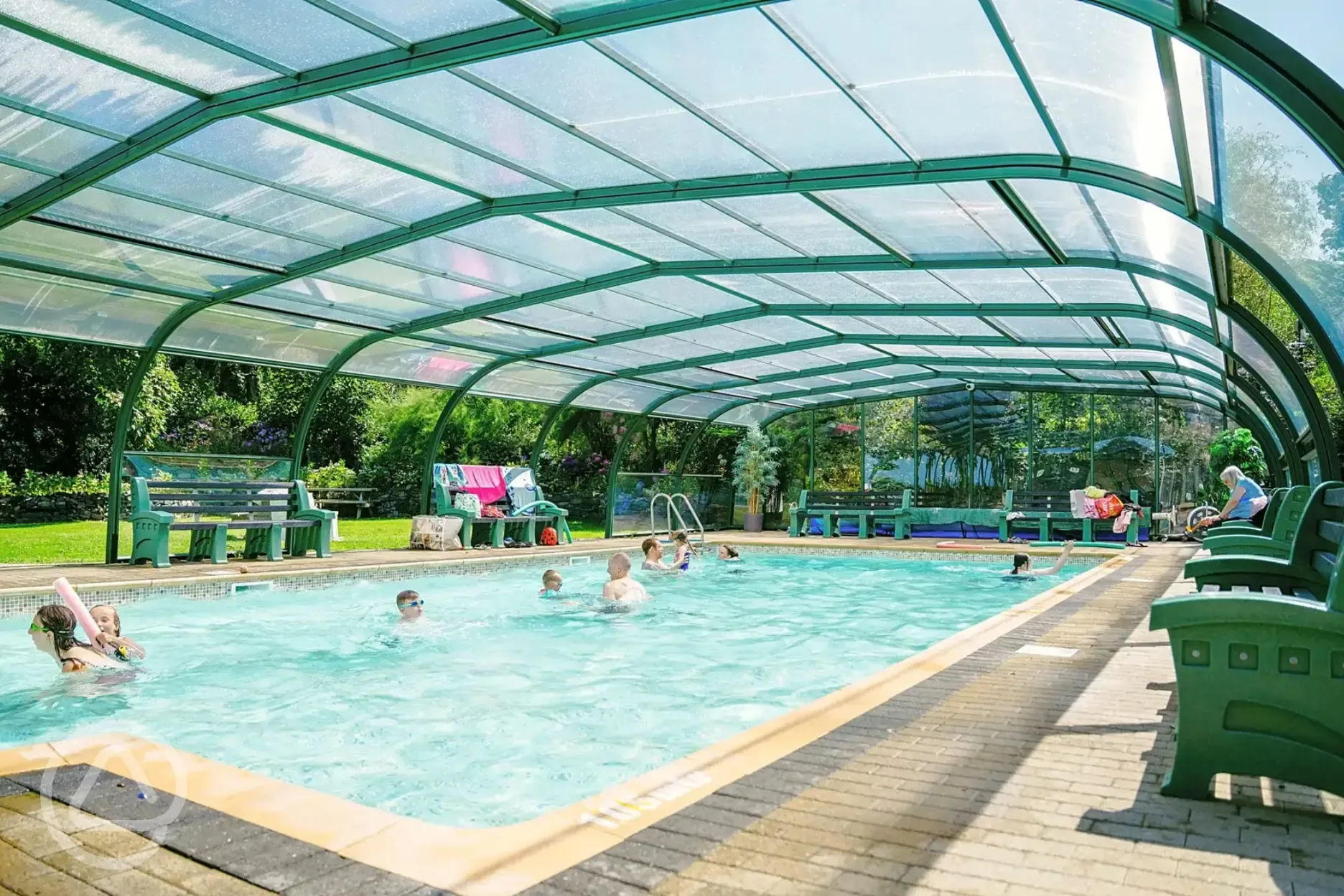 Kids playing in the outdoor heated swimming pool at Morfa Bychan 