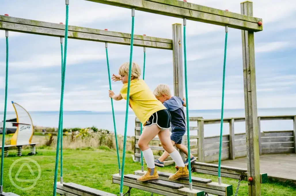 Kids playing on the ropes course in playground