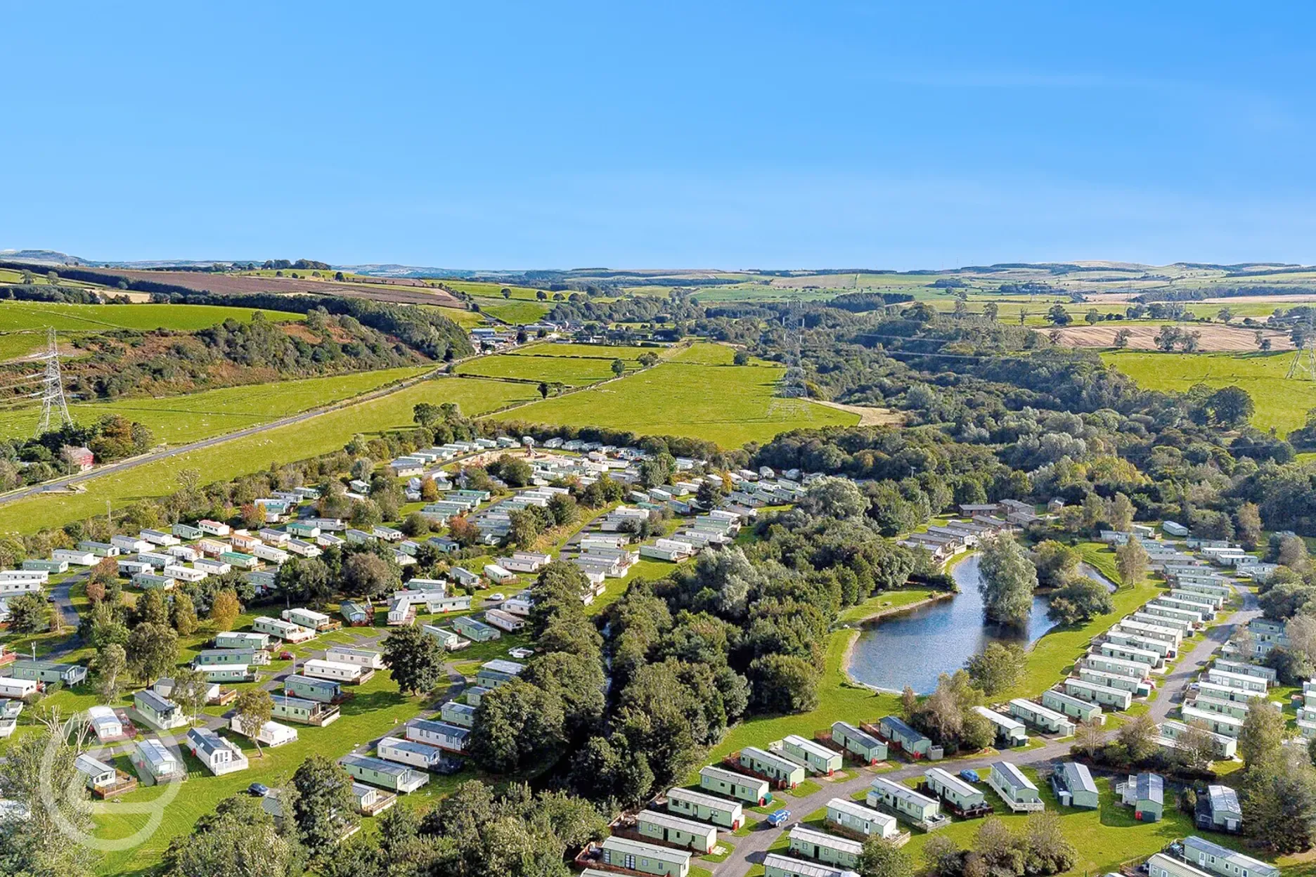 Aerial of Riverside Wooler Holiday Park and the fly fishing lake