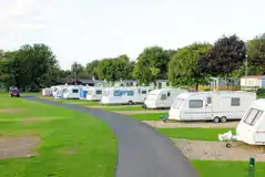 Electric hardstanding touring pitches with grass areas to divide pitches