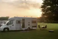 Motorhome on hardstanding pitches at sunset Motorhome on hardstanding pitches at sunset