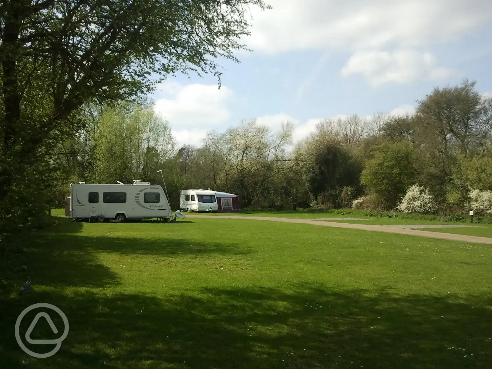 Caravans on electric grass touring pitches with awning space