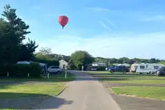 Hardstanding pitches at Hurley Riverside Park with a visiting hot air balloon Hardstanding pitches at Hurley Riverside Park with a visiting hot air balloon