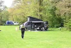 Campervan and tent on an electric grass pitch Campervan and tent on an electric grass pitch