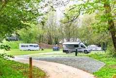 Overview of the gravel and grass touring pitches at The Green Caravan Park