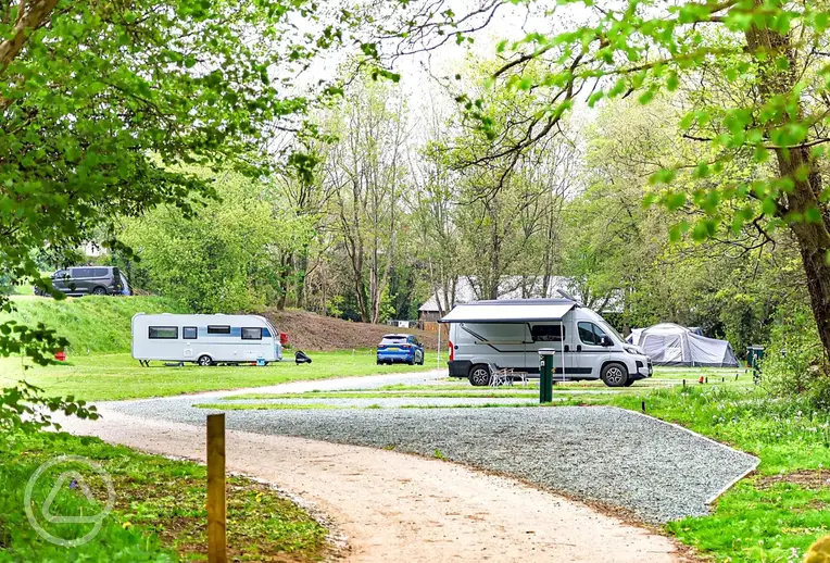 Overview of the gravel and grass touring pitches at The Green Caravan Park
