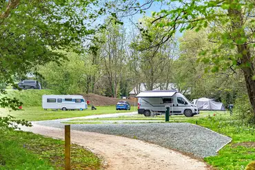 Overview of the gravel and grass touring pitches at The Green Caravan Park