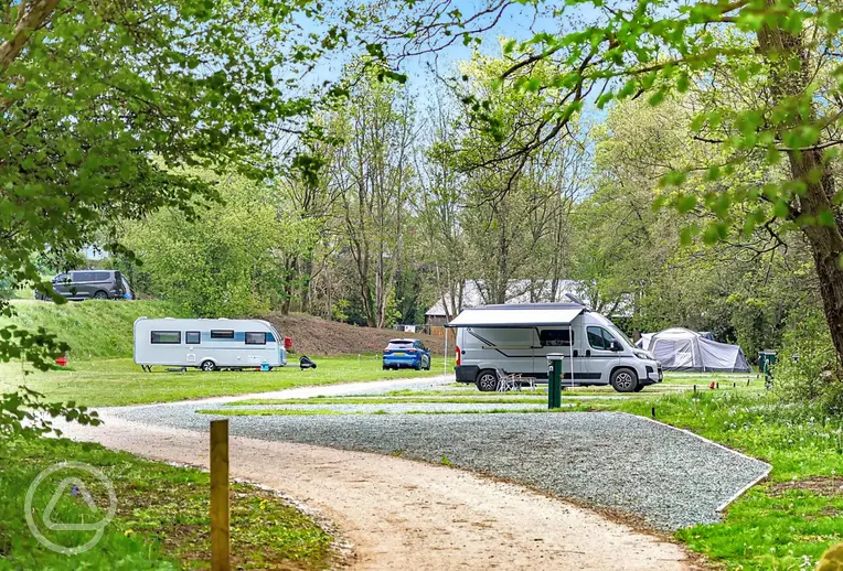 Overview of the gravel and grass touring pitches at The Green Caravan Park