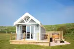 Deluxe ensuite beach hut with a wood-fired hot tub, fire pit and seating