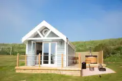 Deluxe ensuite beach hut with a wood-fired hot tub, fire pit and seating Deluxe ensuite beach hut with a wood-fired hot tub, fire pit and seating