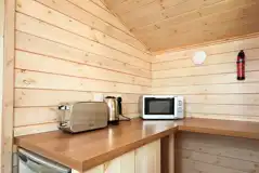 Standard beach hut kitchen area with toaster, kettle, microwave, and fridge Standard beach hut kitchen area with toaster, kettle, microwave, and fridge