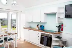 Deluxe beach hut kitchen with a microwave, hob, fridge, kettle and toaster Deluxe beach hut kitchen with a microwave, hob, fridge, kettle and toaster